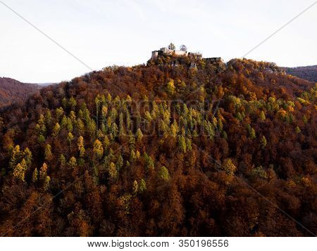 The Ruins Of Burg Hohenurach Towering Above A Colorful Autumn Forest Near Bad Urach In Baden-wuertte