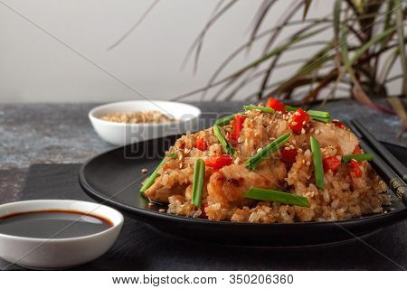 Tori Chahan Fried Japanese Rice With Vegetables And Chicken In Soy Sauce In A Black Plate On A Servi