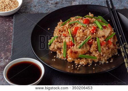 Tori Chahan Fried Japanese Rice With Vegetables And Chicken In Soy Sauce In A Black Plate On A Servi
