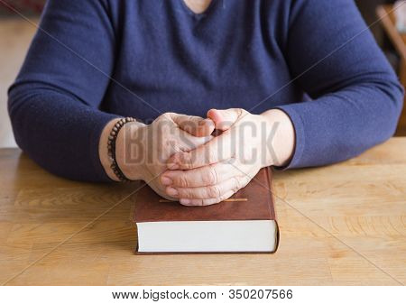 Old Woman Hands On The Open Prayer Ukraine Bible. Reading The Book. Praying.