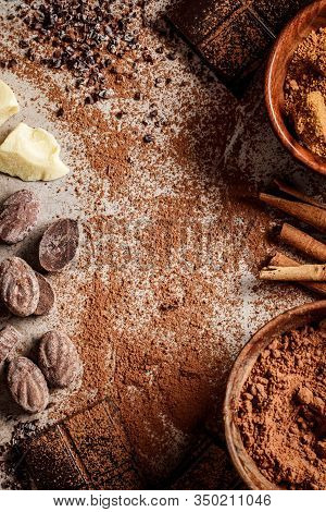 Ingredients For Making Chocolate Background. Cocoa, Cocoa Butter, Sugar, Cinnamon And Coconut Oil On