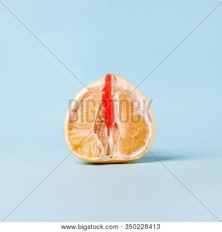 Half Of Pomelo Citrus With Honey Wax Red On Blue Background. Clitoral Or Vaginal Orgasm. Vagina Symb