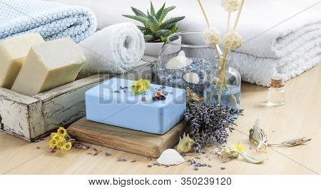 Bath Spa Setting With Natural Soaps. Lavender Spa Treatment, Towels, Sea Salt And Dried Herbs. Aroma
