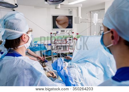 Arthroscope Surgery. Orthopedic Surgeons In Teamwork In The Operating Room