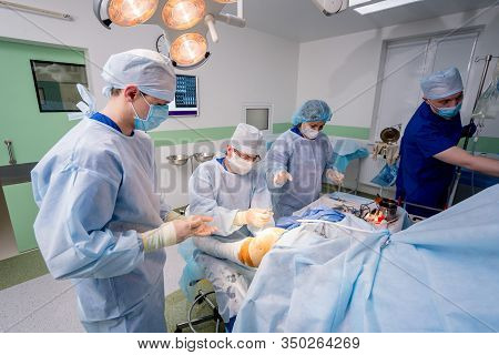 Arthroscope Surgery. Orthopedic Surgeons In Teamwork In The Operating Room