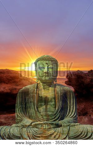 Figure Of A Buddha With A Lake At Sunrise In The Background