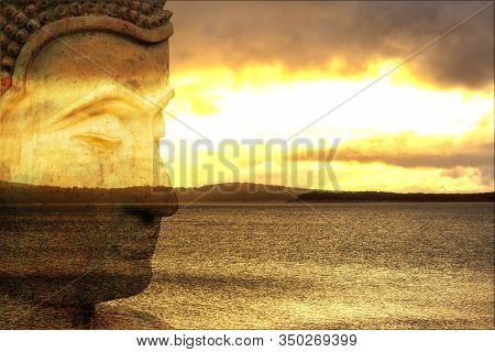Figure Of A Buddha With A Lake At Sunrise In The Background