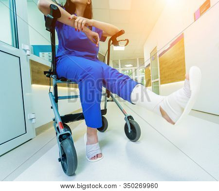 Patient On Rollator With Hand Brakes Moving In Hospital