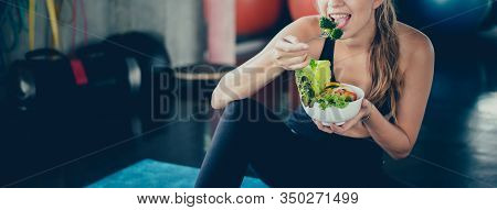 Beautiful Young Lady With Salad In The Gym. Sport Women Exercise With Healthy Food. Mental Health An