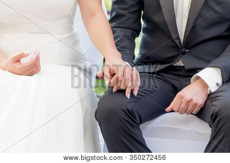 Wedding Groom And Bride Couple Hold Hands At Marriage Ceremony. Elegant Husband With Dark Suit And S