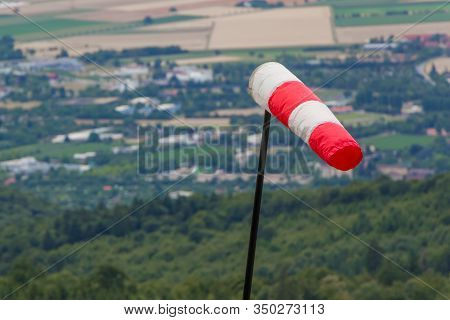 Red And White Windsock Measuring Stormy Windy Weather At Hill. Meteorology Measurement Instrument Sh