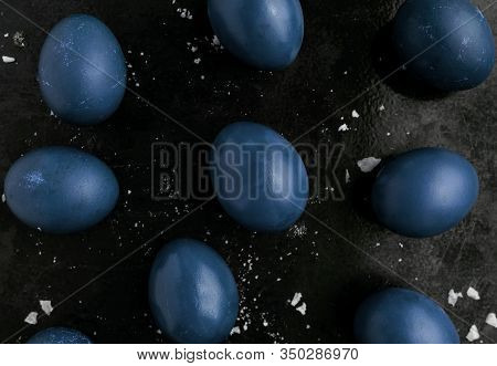 Easter Eggs Painted In Classic Blue Monochrome Style Close Up On A Black Surface With Icing Crumbs.
