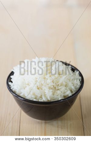Steamed Rice, Jasmine Rice
Thailand Genuine Rice Varieties.rice In Ceramic Bowl On A Black Backgroun