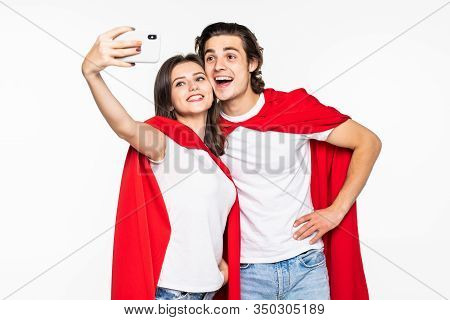 Young Couple Hero In Red Cout Take Selfie On The Phone Isolated On White Background