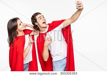 Young Couple Hero In Red Cout Take Selfie On The Phone Isolated On White Background