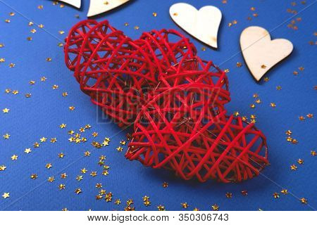 Beautiful Red And Wooden Hearts On The Cornflowerblue Background In The Golden Star Sequins. St Vale