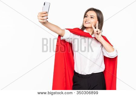 Superhero Woman. Young And Beautiful Woman In Red Cout Take Selfie On The Phone Isolated On White Ba