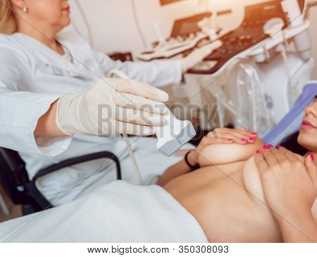 Gynecologist Performing Breast Examination For Her Patient