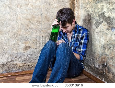 Sad Young Man In Alcohol Addiction With A Beer