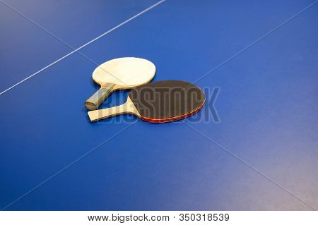 Tennis Rackets For Pingpong Table Tennis. Details Of Pingpong Table With Playing Equipment On A Blue