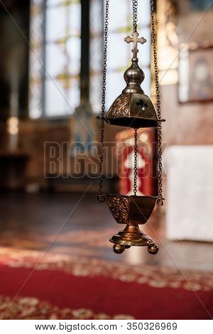 A Priests Censer Hangs On An Old Wall In The Orthodox Church. Copper Incense With Burning Coal Insid