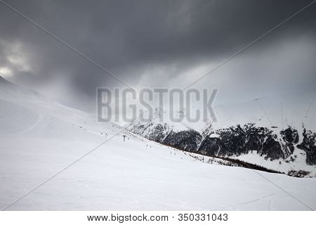 Snowy Ski Slope In High Mountains And Cloudy Storm Sky At Winter Before Blizzard. Ski Area Mottolino