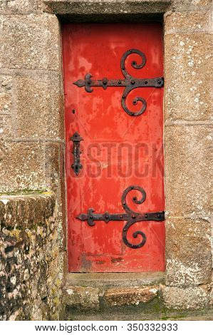 Antique Red Wooden Door With Hinges Of Fort National By Saint-malo Historic City, Brittany, France