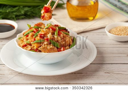 Tori Chahan Fried Japanese Rice With Vegetables And Chicken In Soy Sauce In A Black Plate On A Woode