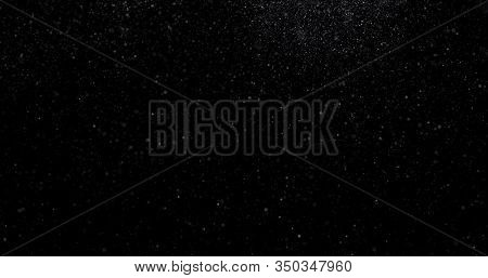 Flying Dust Particles On A Black Background