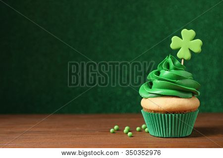 Delicious Decorated Cupcake On Wooden Table, Space For Text. St. Patrick's Day Celebration