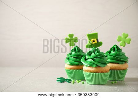 Delicious Decorated Cupcakes On Light Table, Space For Text. St. Patrick's Day Celebration