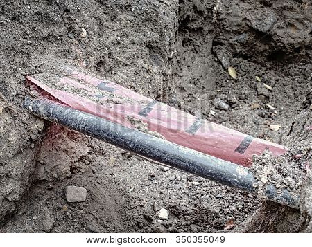 Drink Water Delivering In Steel And Pvc Plastic Pipes Underground. Construction Site Marked With Whi
