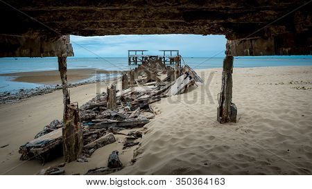 Dilapidated Old Fishing Dock Collapsing Into The Sea Framed By Dock In Pak Nam Pran On The Gulf Of T