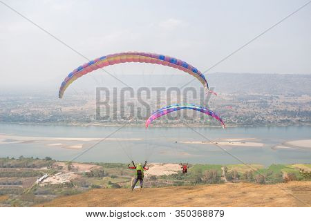 Paraglider On The Ground. Paragliding Flying Over Landscape From Beautiful View Mekong River At Wat 