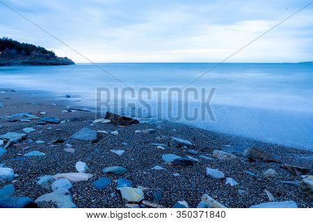 Storm Surges At Slow Shutter Speeds On A Pebble-sandy Beach, The Resort Of Gelendzhik, The Twilight.