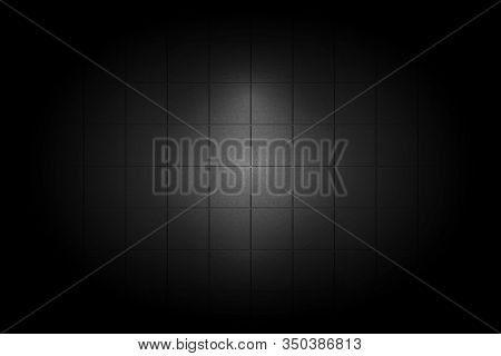Light Shining Down On Black Ceramic Tile Wall In Dark Room With Copy Space, Abstract Background