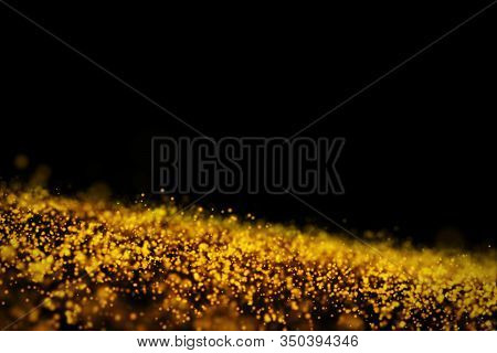 Glow Golden Particles On Black Background