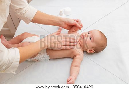 Masseuse Massaging Little Baby, Squeezes Cream. Hypertonicity Correction