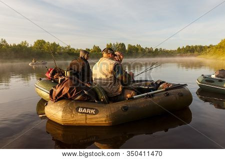 Tuzha, Russia - June 12, 2019: Fishermen Catch Fish On A Rubber Boat On A Forest River. Pizhma River