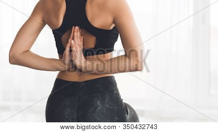 Reverse Prayer Pose. Close Up Back View Of Fit Girl Exercising On Yoga Mat At Home, Stretching Arms,