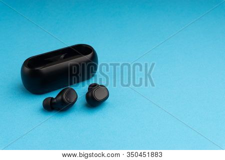 Wireless Earbuds Or Earphones On Blue Background