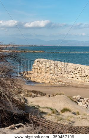 Grec Wall In Platja De Les Muscleres In La Escala Behind The Ruins Of Empuries, In The Province Of G