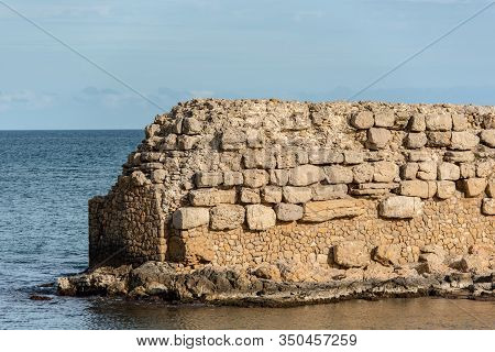 Grec Wall In Platja De Les Muscleres In La Escala Behind The Ruins Of Empuries, In The Province Of G