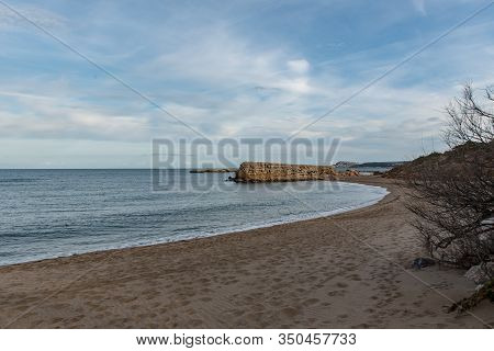 Grec Wall In Platja De Les Muscleres In La Escala Behind The Ruins Of Empuries, In The Province Of G