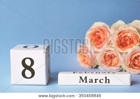Calendar With The Date Womens Day March 8 With Peach Roses On A Purple Background. Selective Focus.