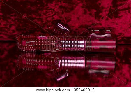 Pink Futuristic Vibrator With A Process For Clitoral Stimulation. Photo Sex Toys On The Mirror..