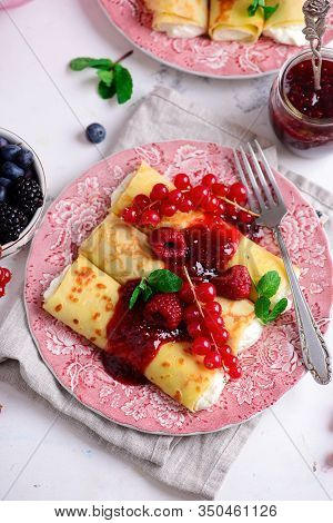 Crepes With Lemon Cream And Raspberry Jam..selective Focus. Style Vintage