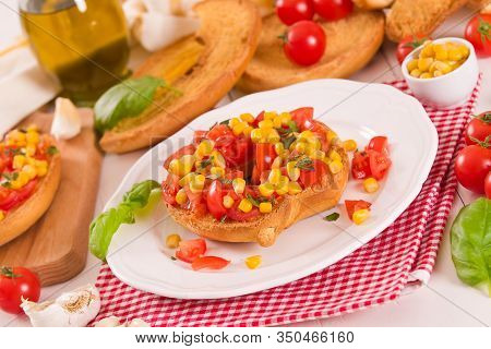 Friselle With Tomatoes And Mais On White Dish.