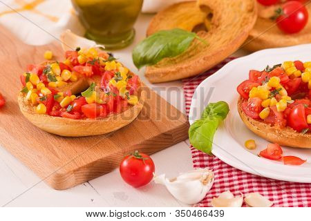 Friselle With Tomatoes And Mais On White Dish.
