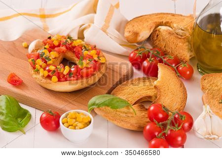 Friselle With Tomatoes And Mais On White Dish.